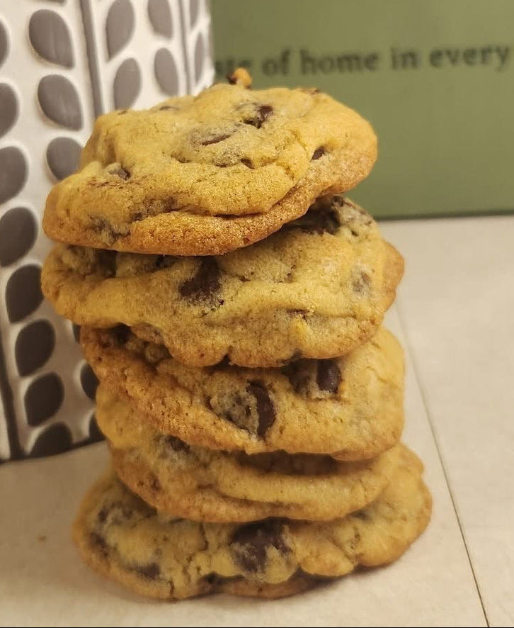 Stack of cookies with a decorative jar and 'Sweet Myrtle' packaging in the background.